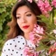 headshot of a woman with flowers